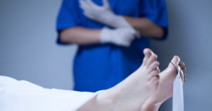 A doctor about to perform an autopsy to show wrongful death.