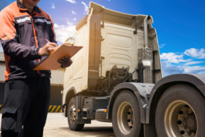 A truck driver filling out a log.