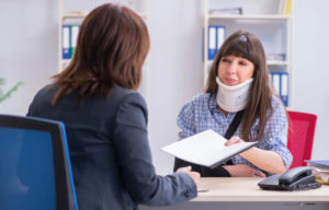 Injured woman talking with a workers comp adjuster about her Georgia injury claim.