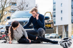 Person laying on the ground after bicycle accident