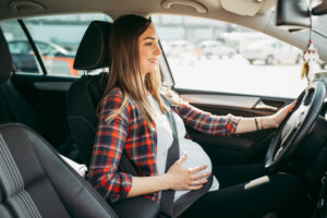 Pregnant woman driving the car.
