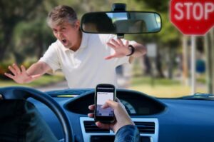 Driver while using his mobile phone almost got hit a pedestrian.