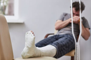 Sad injured man waiting for his lawyer for consultation.