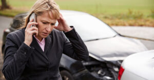 Woman driver feeling dizzy after the car accident in the road.