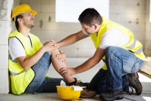 Co-worker helping injured team in the construction.