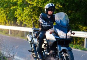 Motorcycle driver wearing safety gears.