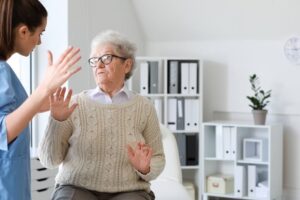 Nursing home staff about to slap scared senior lady.