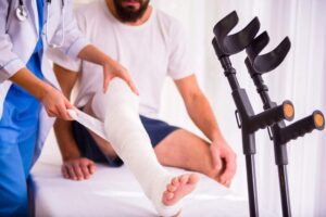 Injured man in the hospital treated by the doctor.