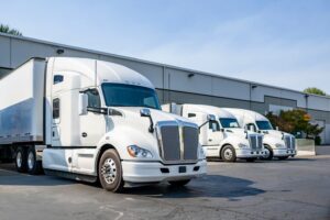 White trucks parking at their warehouse.