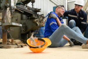 Worker suffering pain from machine malfunction accident.